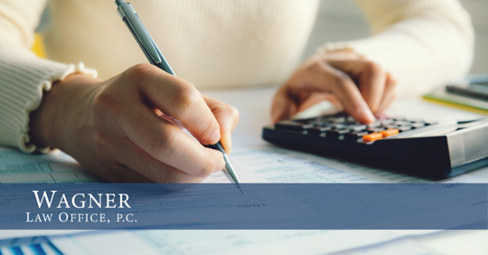 woman computing expenses using a calculator