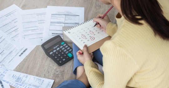 a woman with her documents and calculator