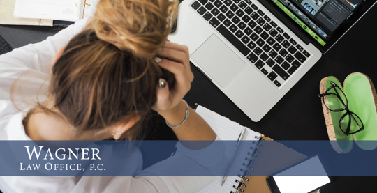 Woman Hanging Head in Front of Computer