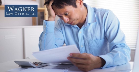 man looking at bills